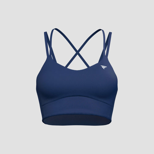 The Cross-Motion Bra in navy with criss-cross straps for lifting and cycling comfort.