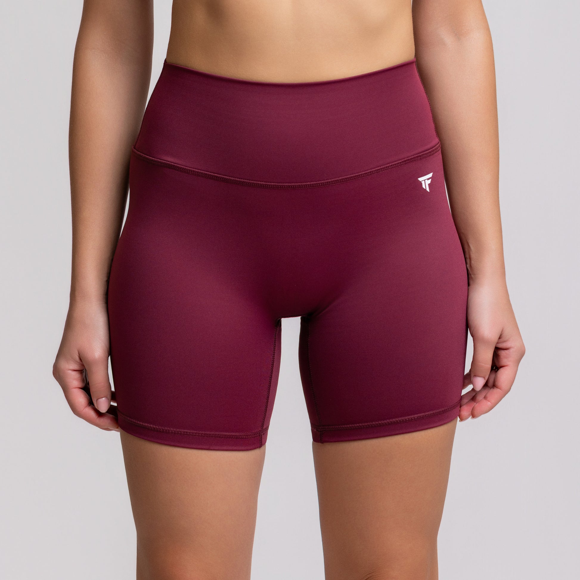TONEFIT women’s 5-inch V-waist Dark Plum shorts front view highlighting high-rise fit and stretch fabric