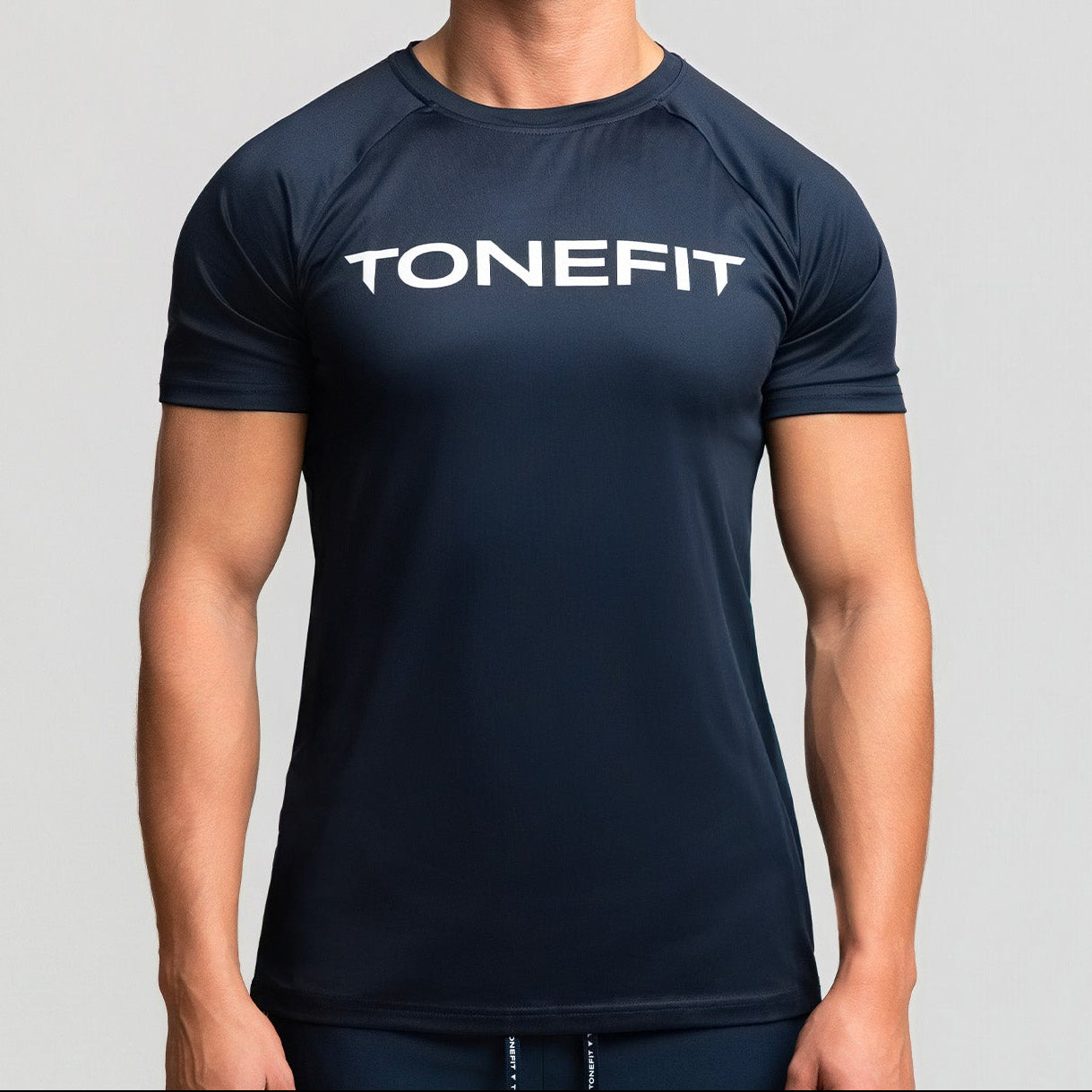 Front view of TONEFIT men’s gunpowder performance t-shirt with model wearing athletic fit.