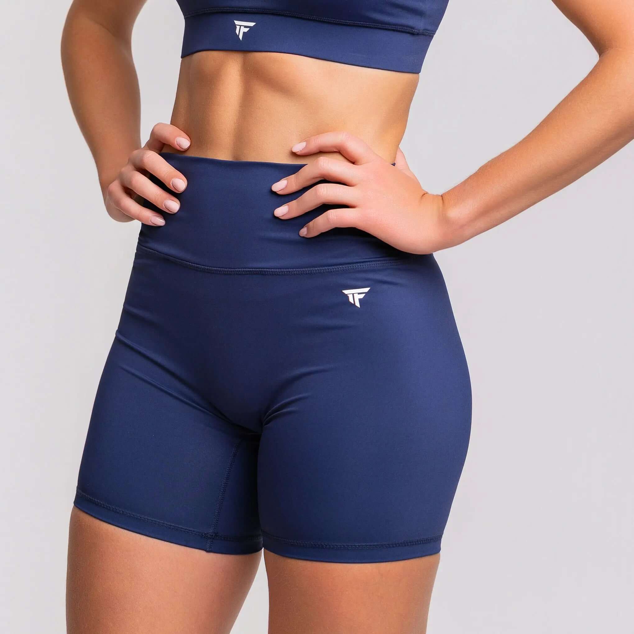 Close-up of a model wearing 5 inch inseam gym shorts from TONEFIT, showcasing the sleek design and supportive fit.