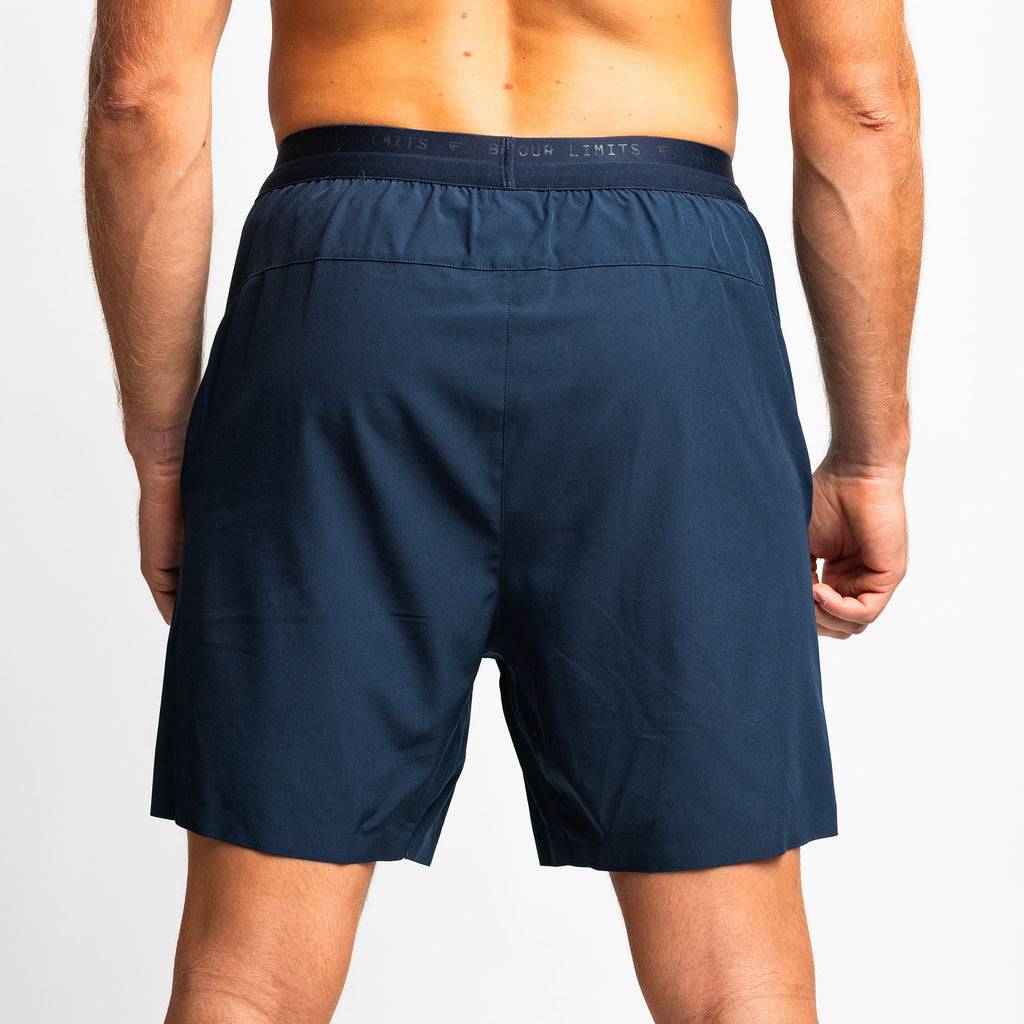 Rear view of TONEFIT men’s dark sapphire training shorts showing tailored fit and waistband.