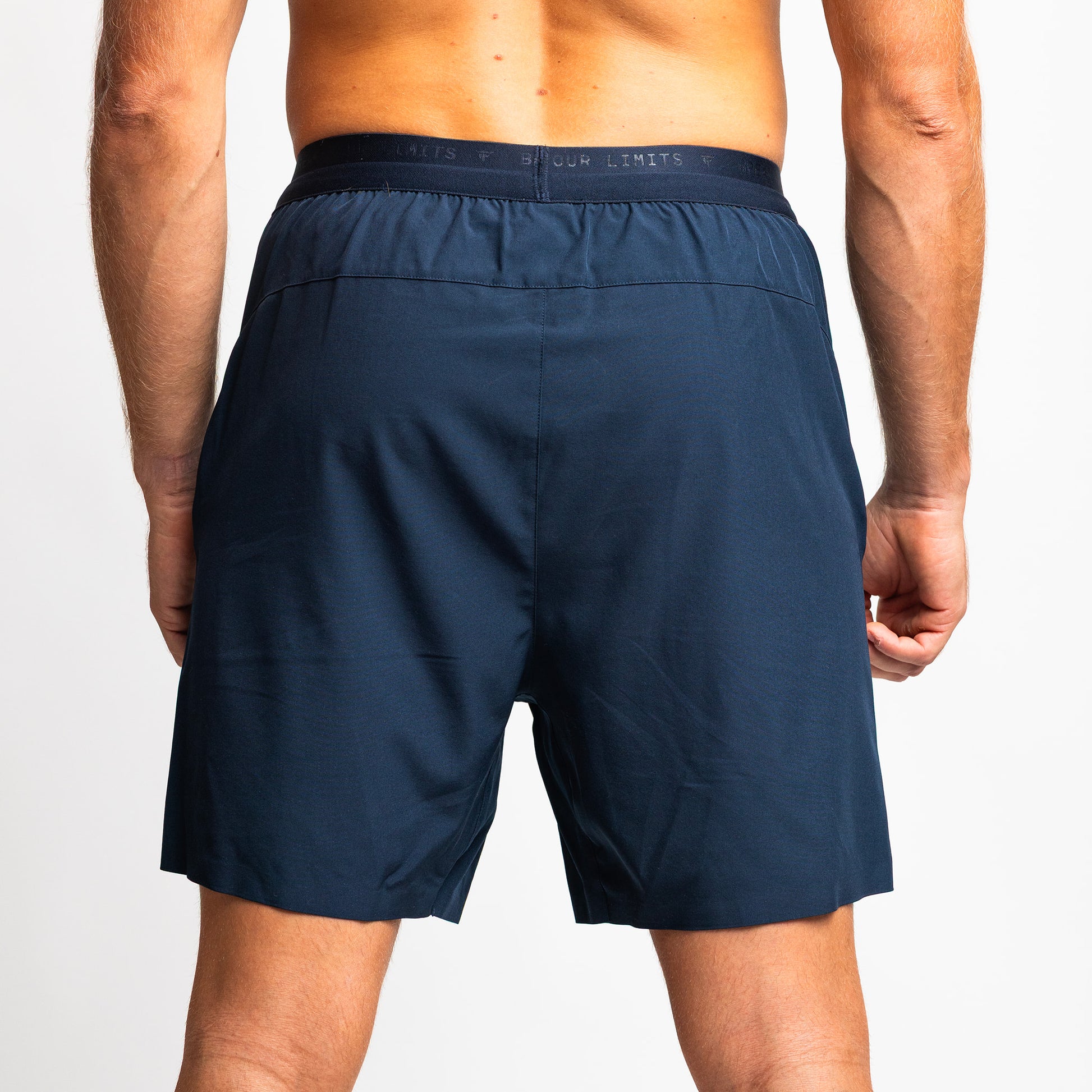 Rear view of TONEFIT men’s dark sapphire training shorts showing tailored fit and waistband.
