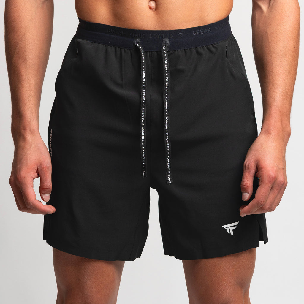 Front view of TONEFIT men’s gunpowder performance shorts with drawstring waistband and logo.
