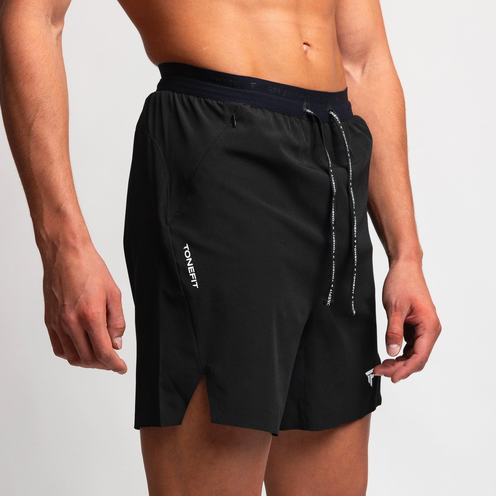 Side view of TONEFIT men’s gunpowder athletic shorts highlighting stretch-fit design.