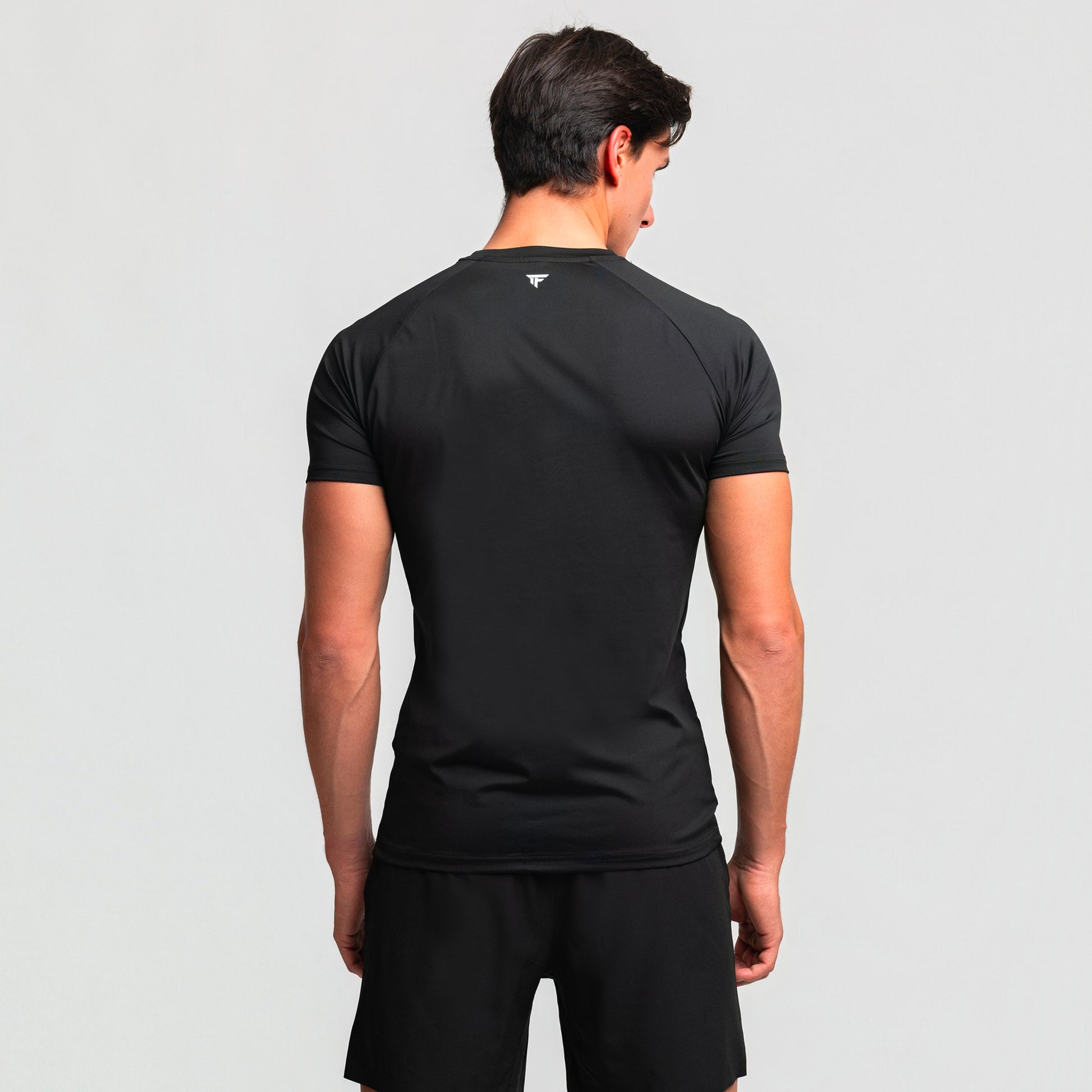 Back view of TONEFIT men’s gunpowder athletic t-shirt featuring raglan sleeves and sleek fit.
