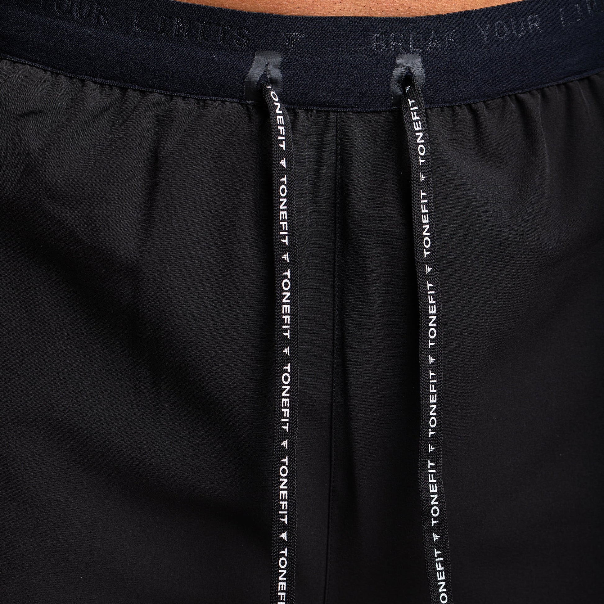  Close-up of waistband and drawstrings on TONEFIT gunpowder men’s performance shorts.