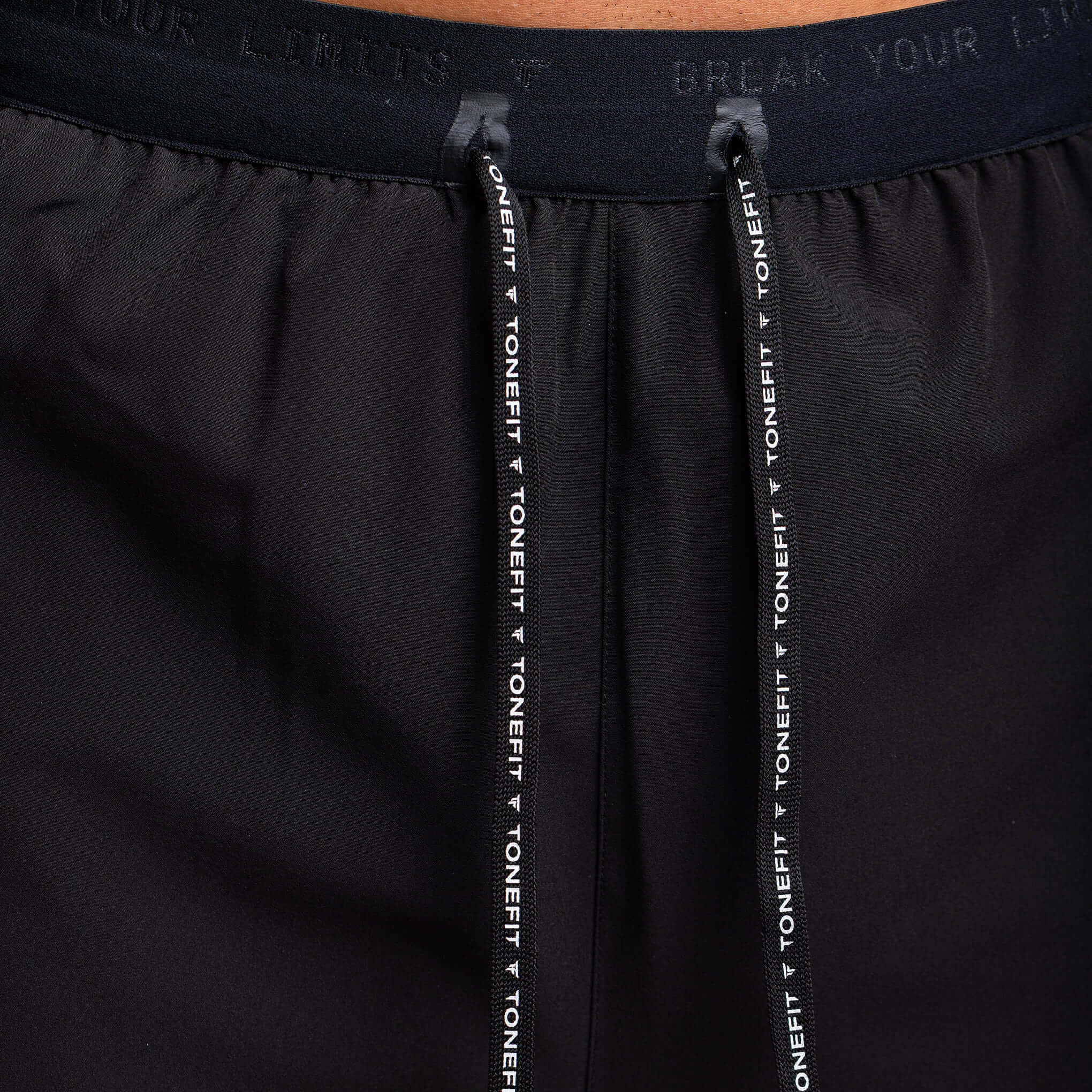 Close-up of drawstring on 2-in-1 hybrid training shorts by TONEFIT with adjustable waistband.