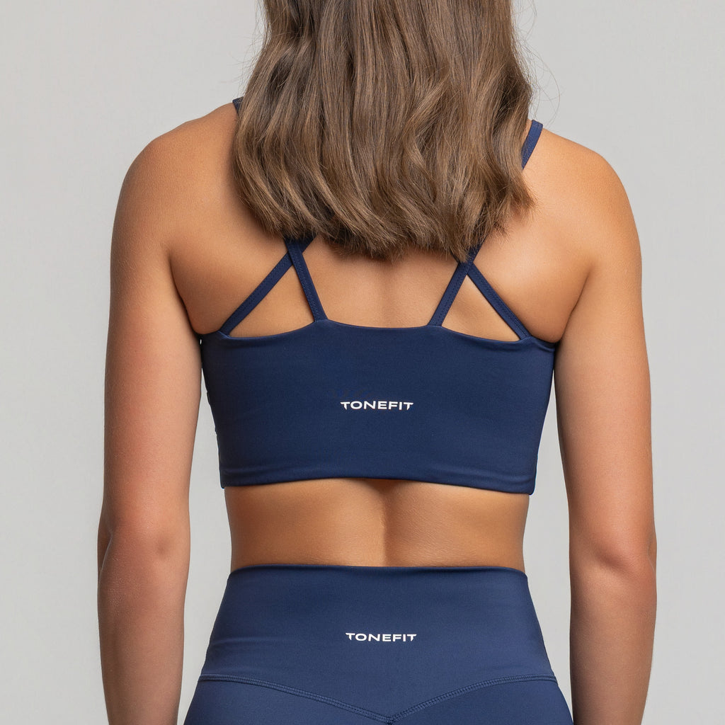 Back view of TONEFIT women’s Criss-Cross Strappy Bra in Deep Sapphire featuring cross-back straps and logo