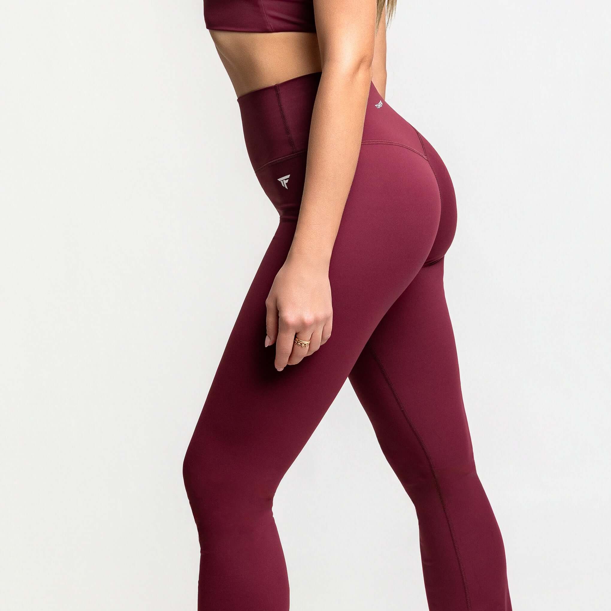 Side view of high waisted flare leggings in burgundy, showcasing the stylish design from TONEFIT.