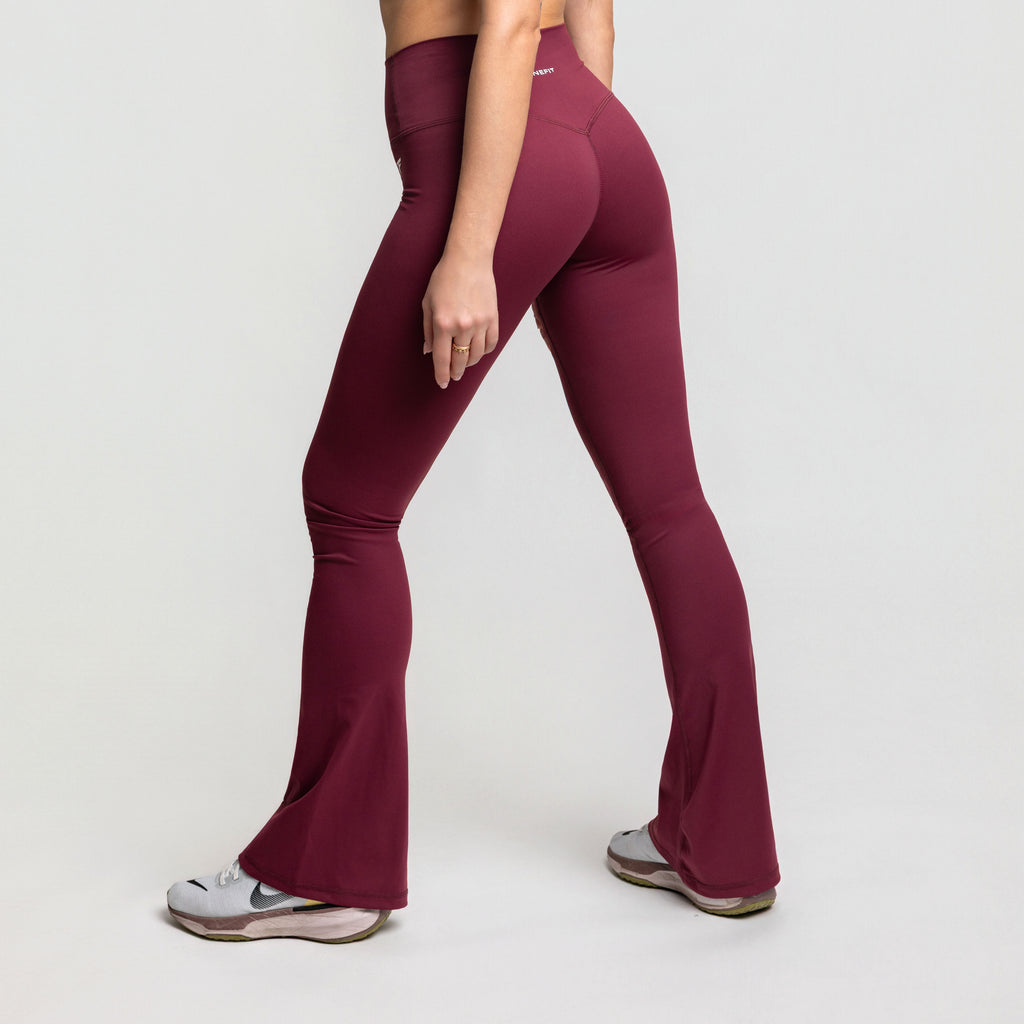 Maroon leggings worn by a person on a white background