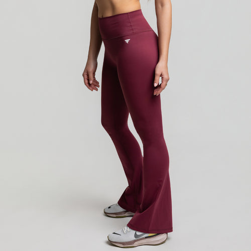 Angled front view of Dark Plum Flare Leggings highlighting sculpting waist and flare silhouette