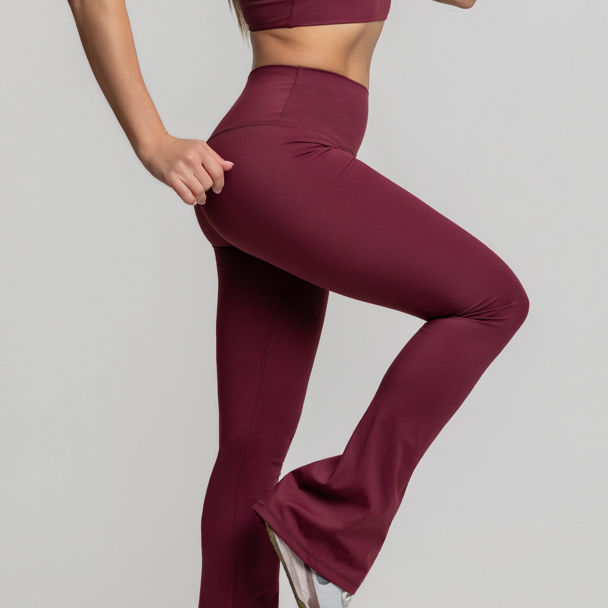 Lifestyle seated shot in Dark Plum Flare Leggings highlighting comfort and flexibility