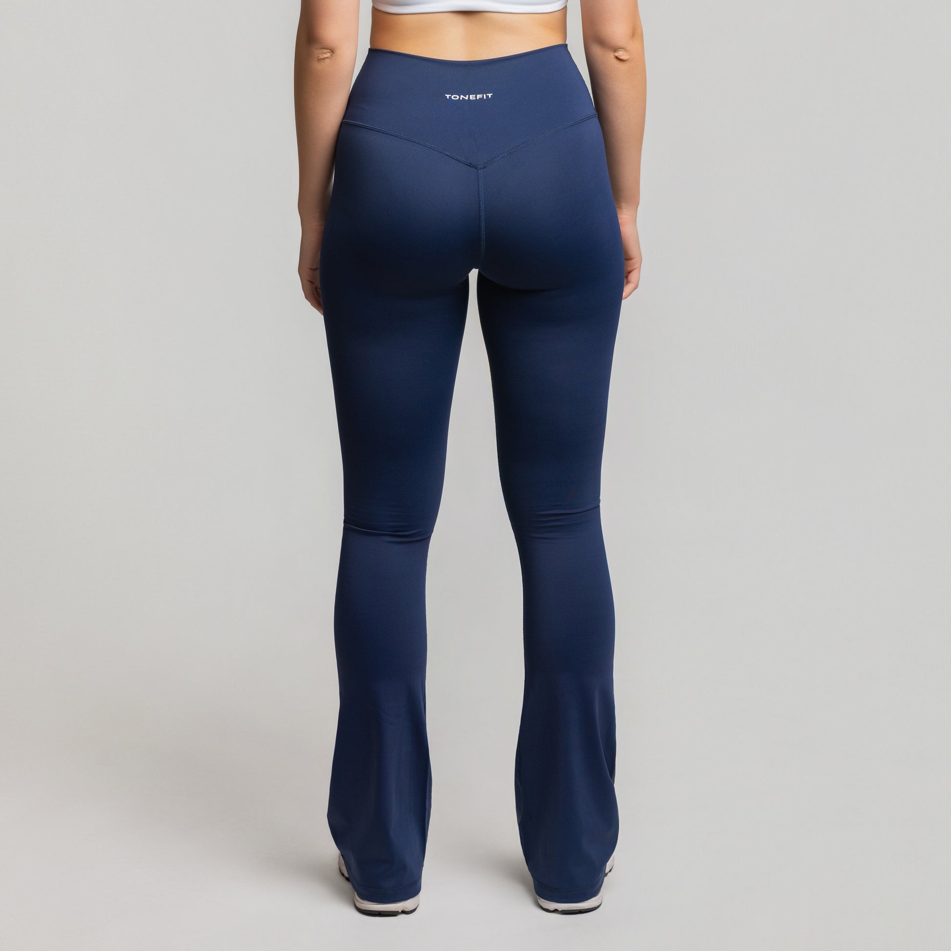 Back view of Deep Sapphire Flare Leggings showing seam detailing and high-rise sculpt