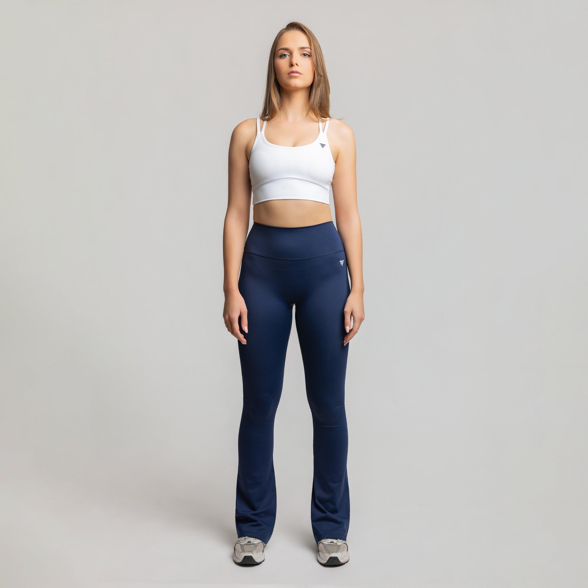 Front view of TONEFIT women’s Flare Motion Leggings in Deep Sapphire showing high-waisted fit and flared hem