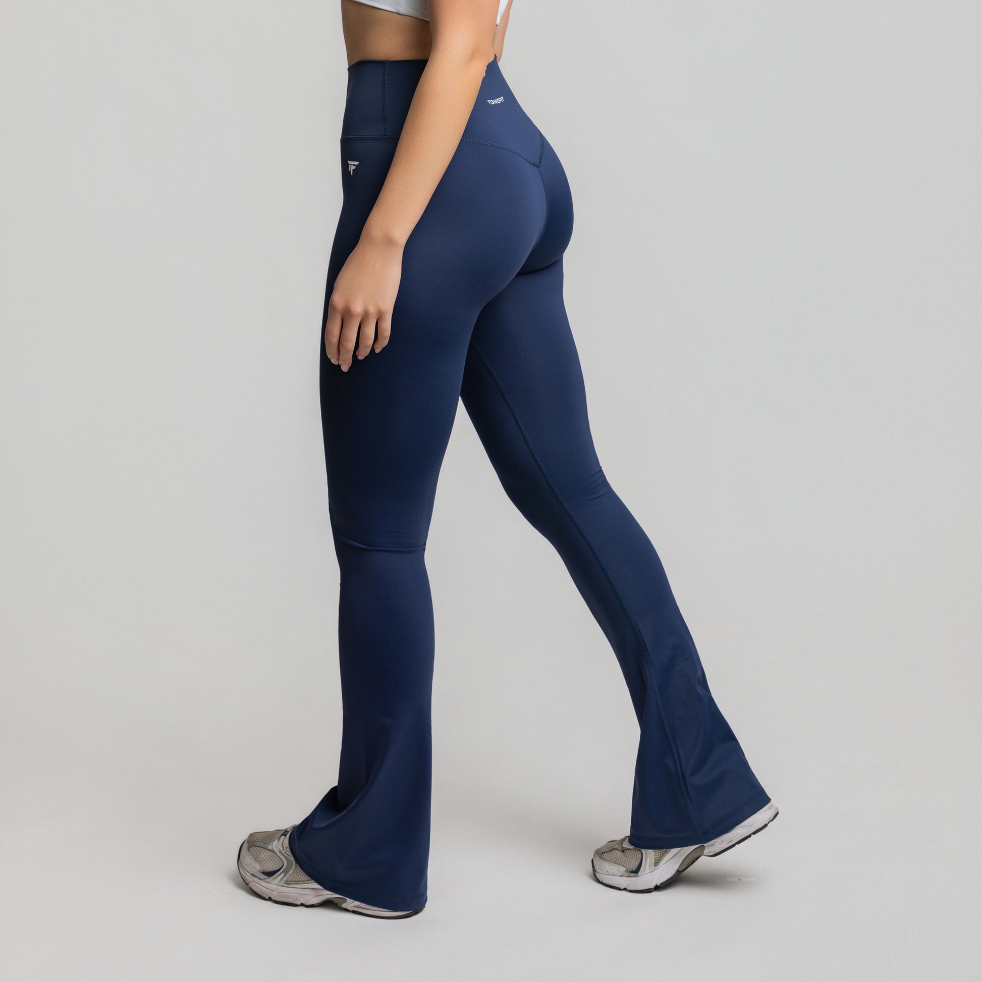 Side view of Deep Sapphire Flare Leggings showing fit through thigh and flared ankle
