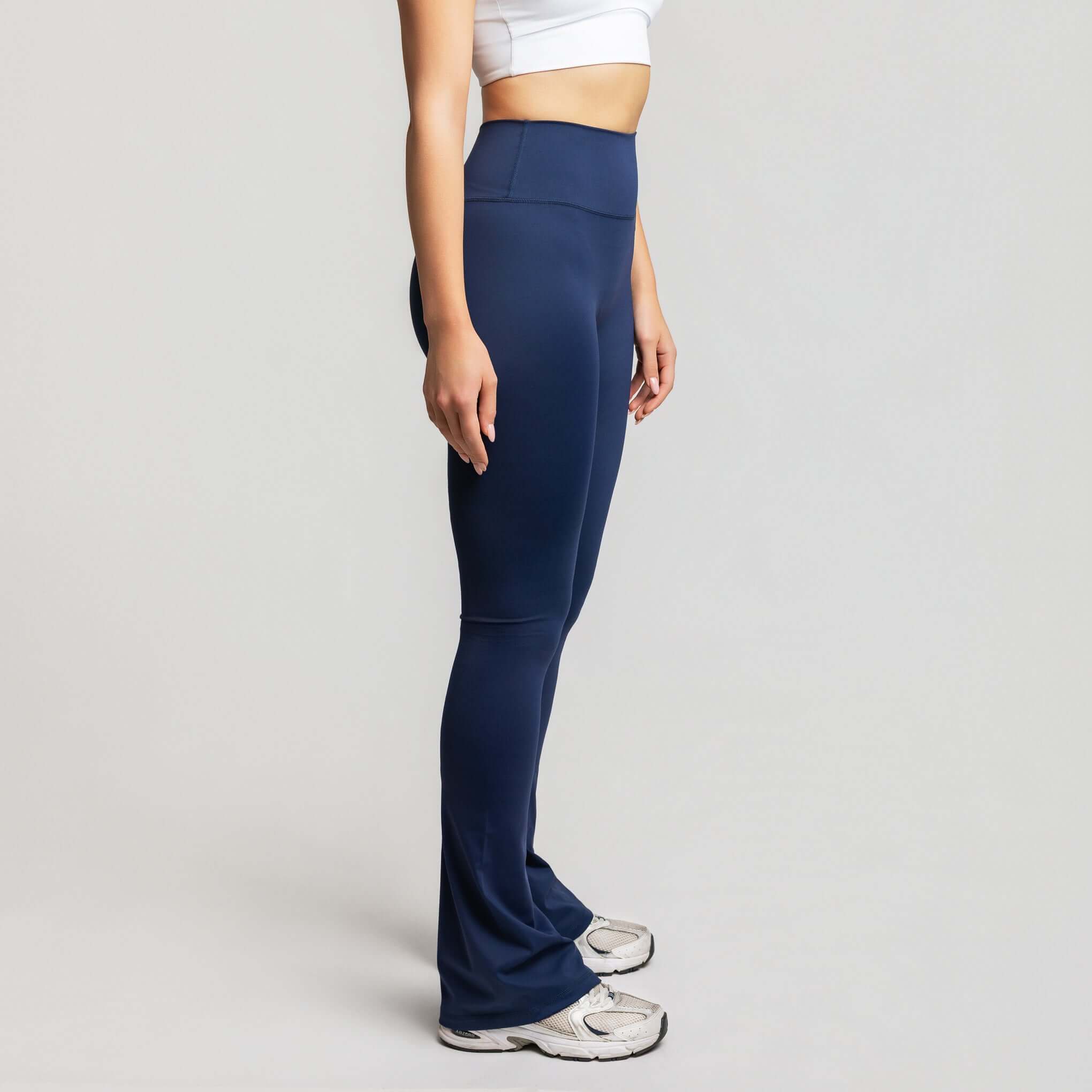 Side view of high waisted flare leggings, The Flare Motion by TONEFIT, showcasing a modern studio aesthetic.