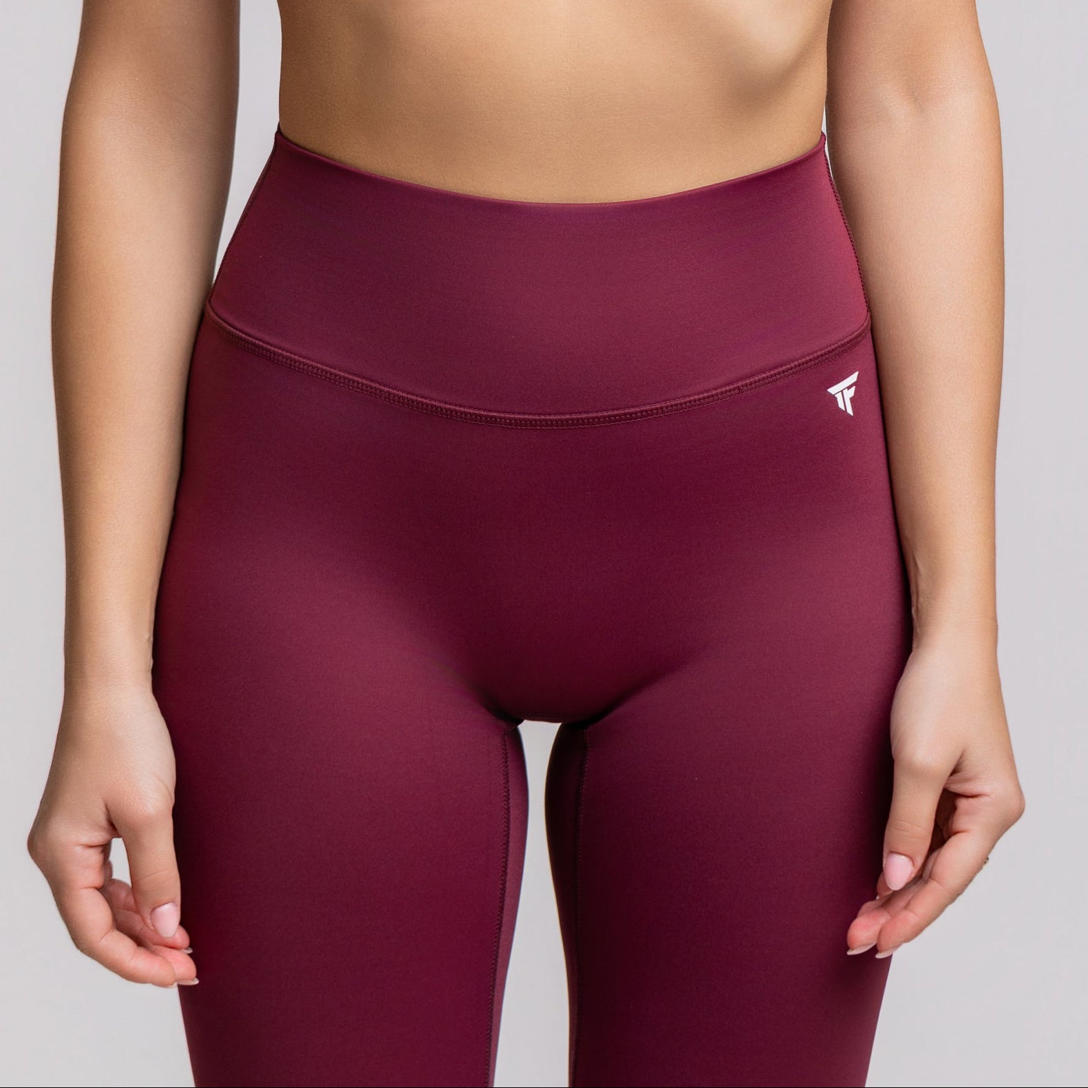 Front close up view of TONEFIT V-Waist Sculpt Leggings in Dark Plum highlighting high waist and sleek design
