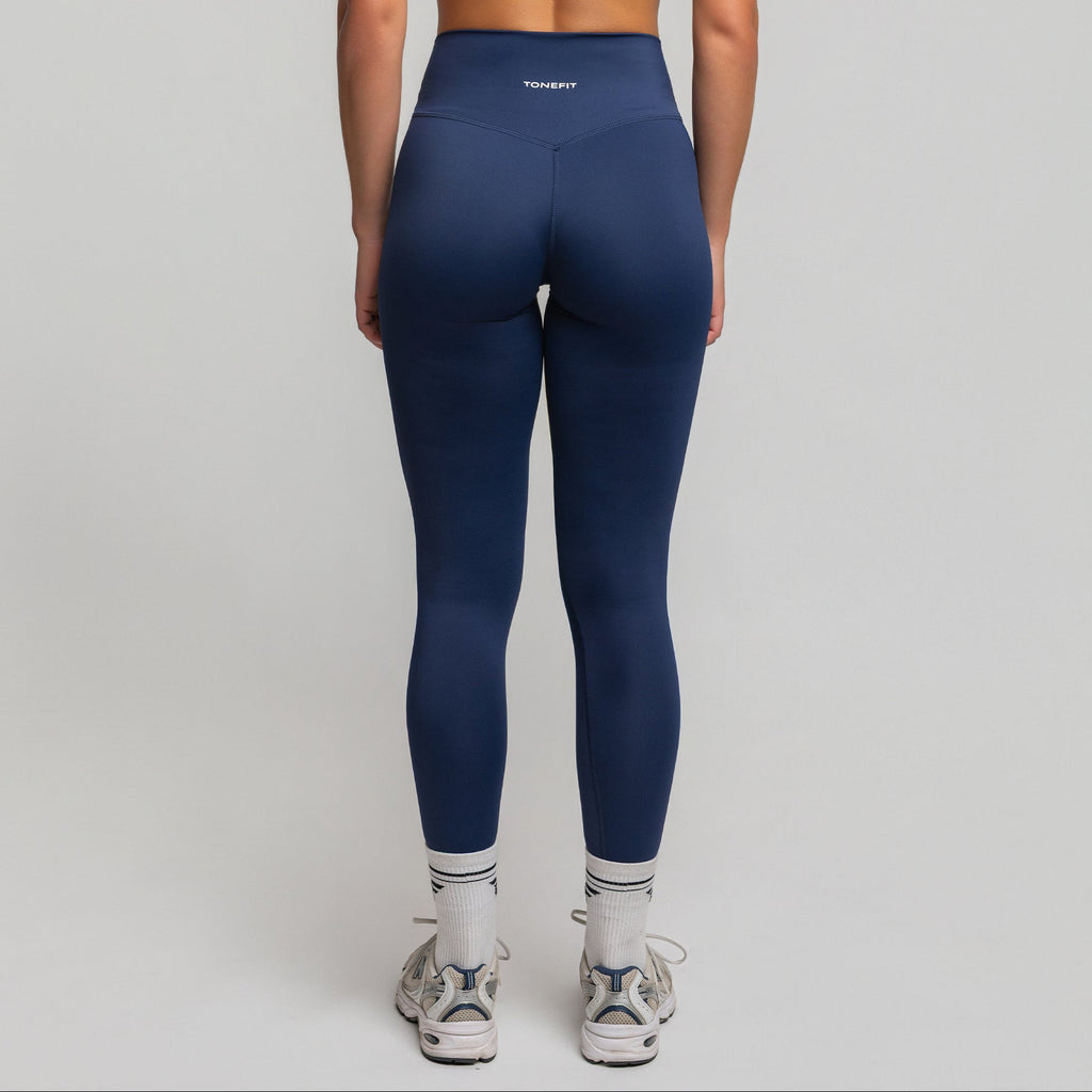 Back view of Deep Sapphire V-Waist Sculpt Leggings featuring TONEFIT logo and curve-enhancing seams