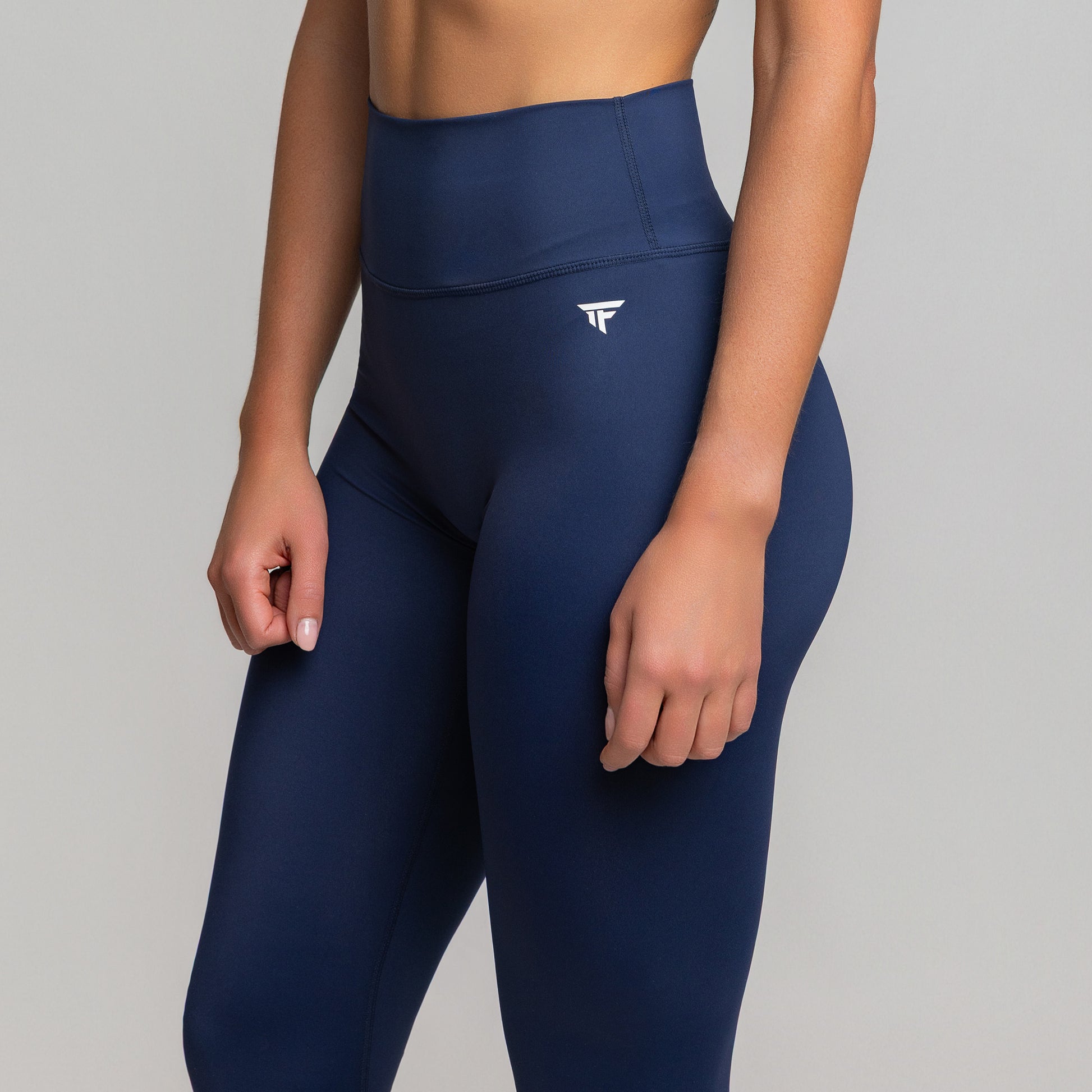 Side view of Deep Sapphire TONEFIT V-Waist Leggings highlighting sculpting fit and curved waistband