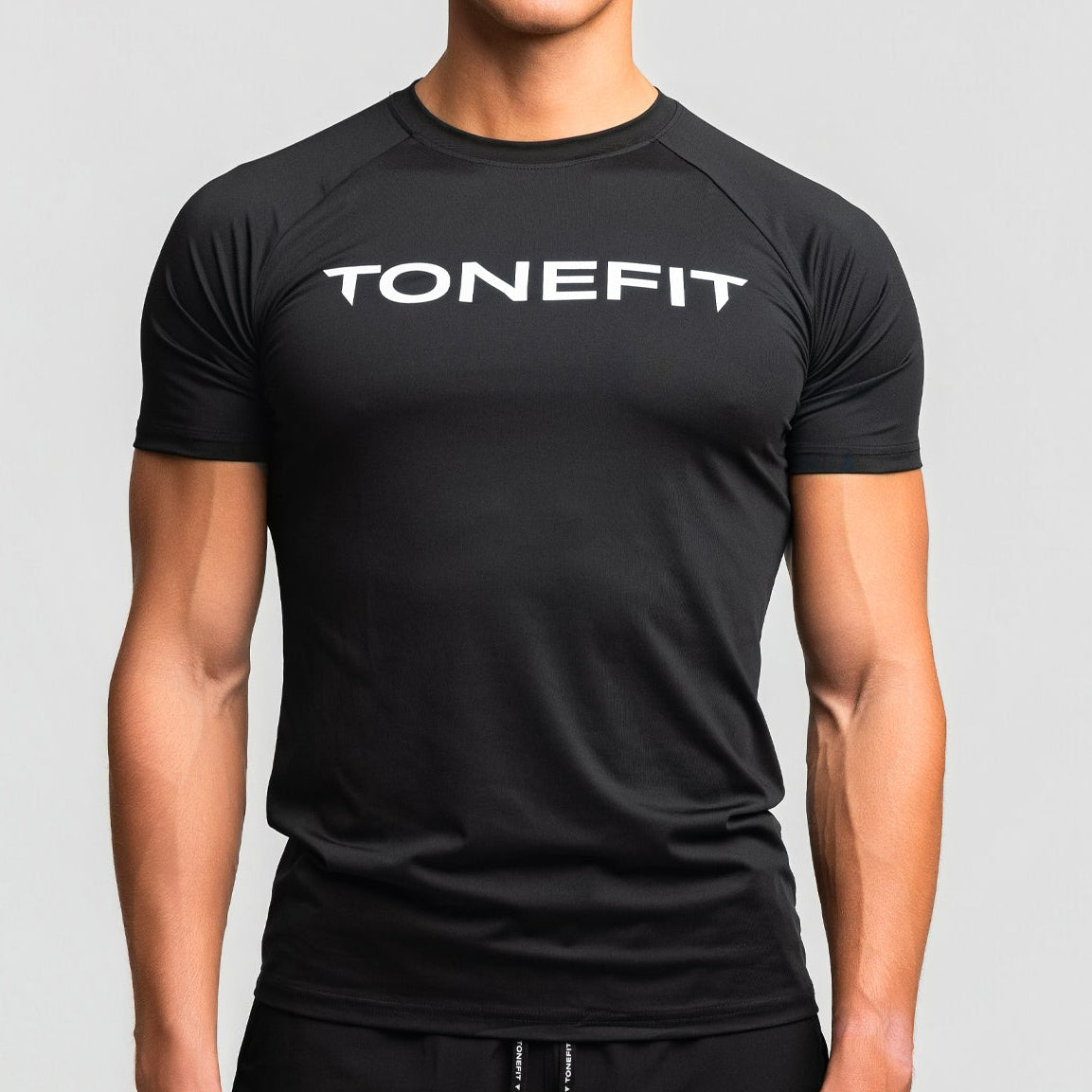 Front view of TONEFIT men’s gunpowder performance t-shirt with model wearing athletic fit.