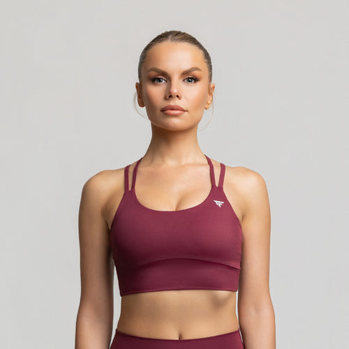 TONEFIT women’s criss-cross back sports bra in deep plum – front view with scoop neckline