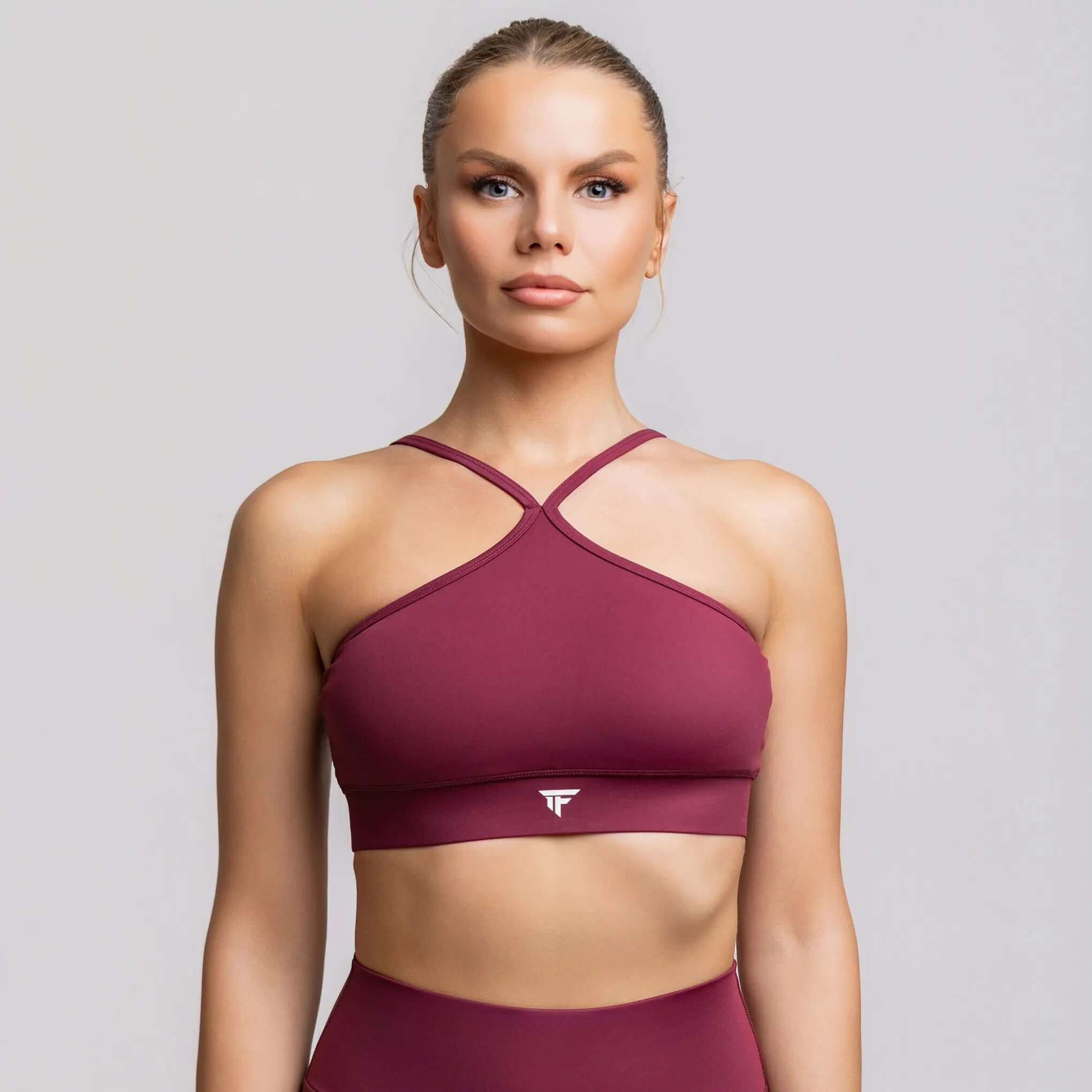 Halter neck sports bra in burgundy, designed for studio practice and performance by TONEFIT.