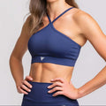 Halter neck sports bra in navy blue, designed for performance and style, perfect for active studio practice.