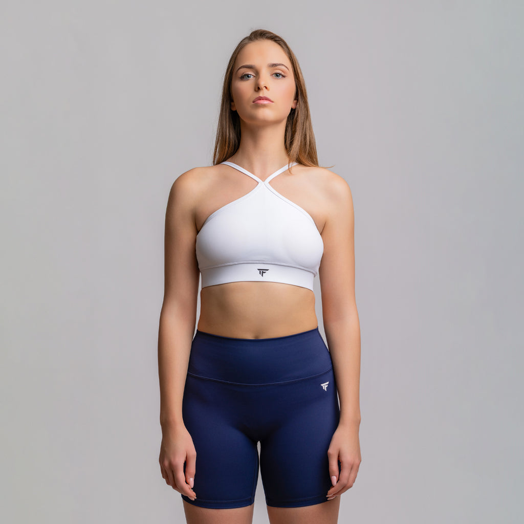 TONEFIT halter crop bra in white paired with navy shorts – full front view of matching activewear set