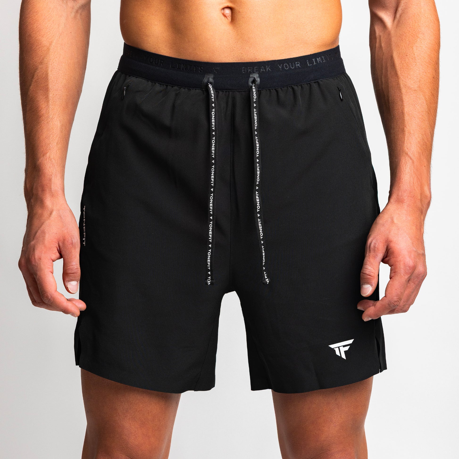 Close-up front view of TONEFIT men's black performance shorts showing logo and drawstring 