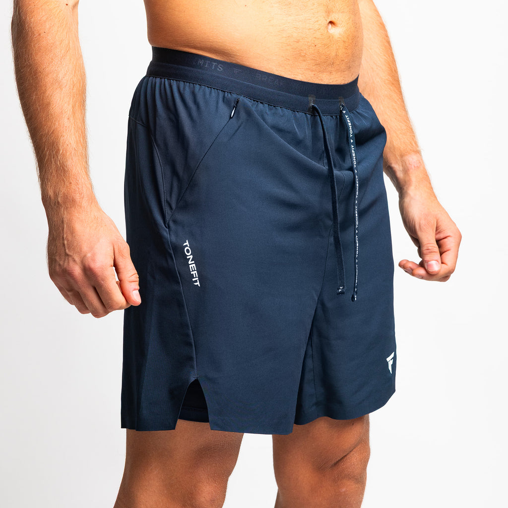 Side view of TONEFIT men's navy athletic shorts with logo and side pocket detail 